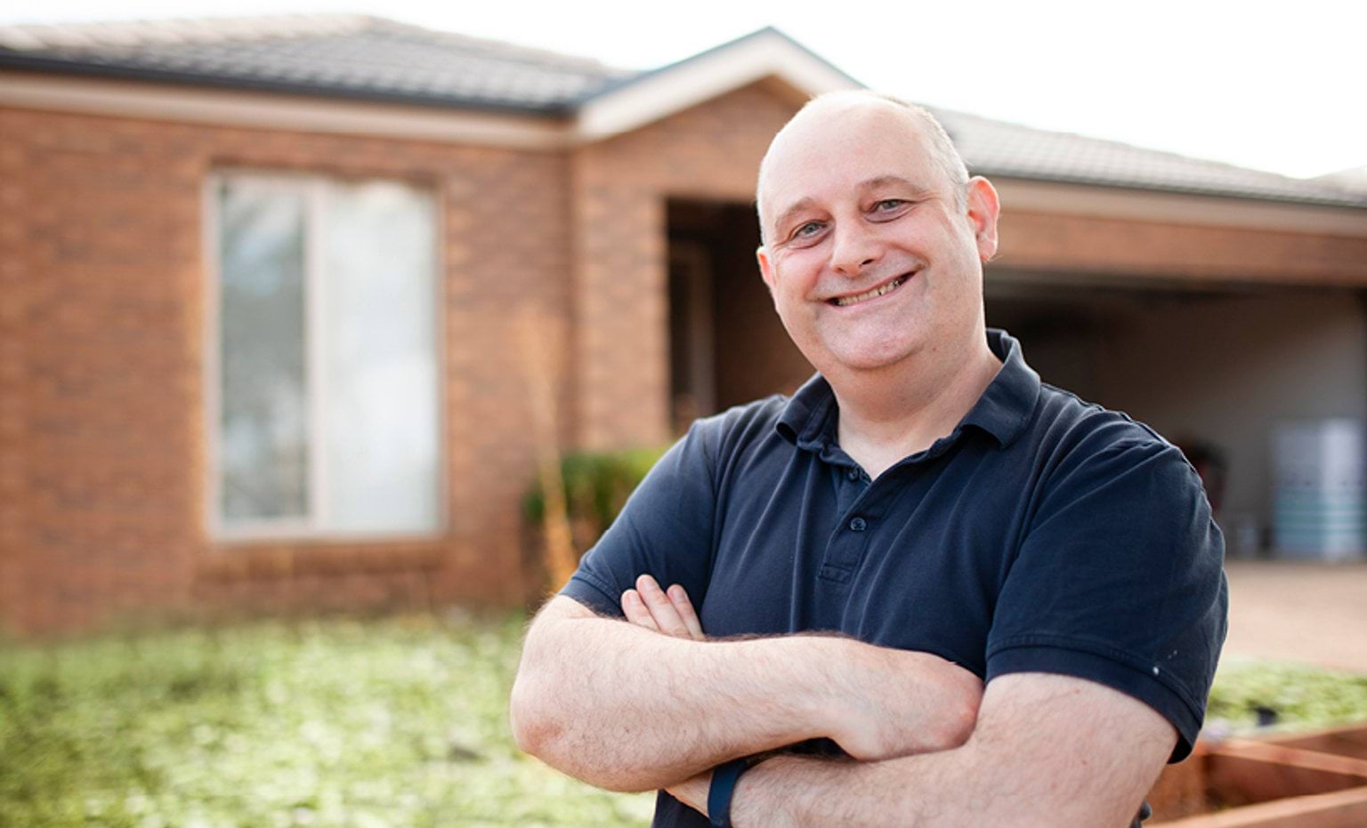 Richard Dowson Man standing in front of his house with sola panels