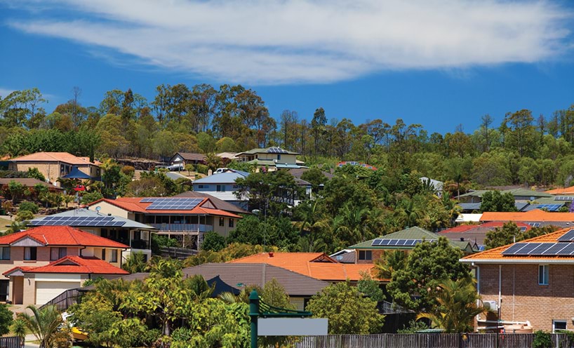 Houses on hillside with solar panels