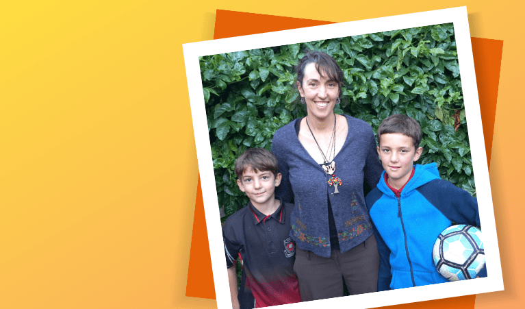 A woman and her two children posing for photo