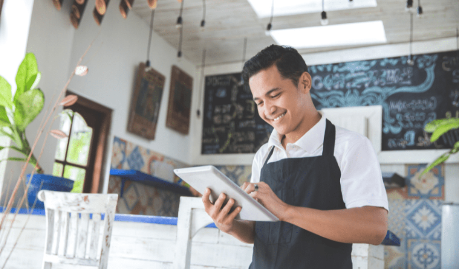 Solar for Business: Where to start Portrait of young male cafe owner with tablet