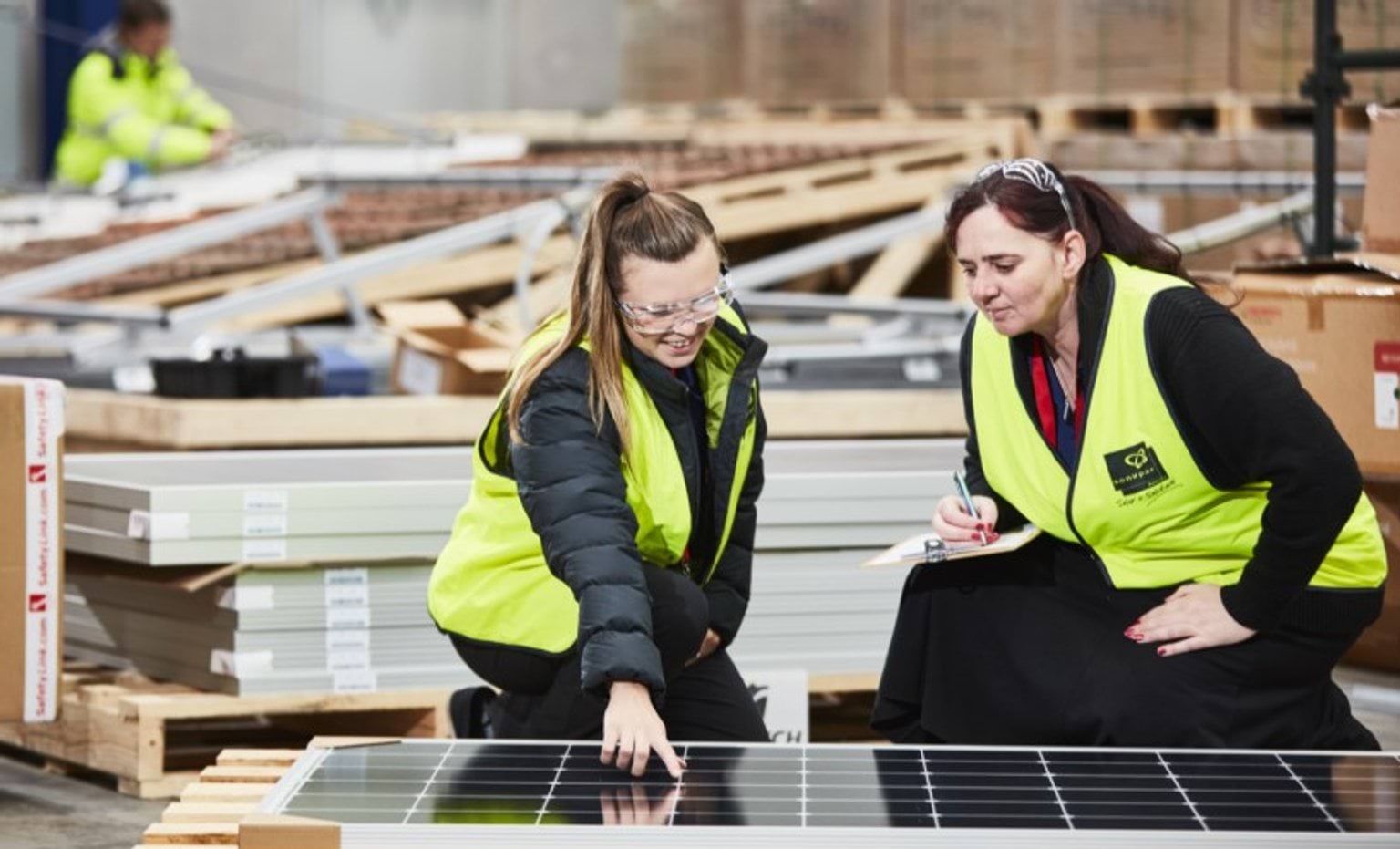 More women powering Victoria‘s renewable future Two women at work looking at a solar panel