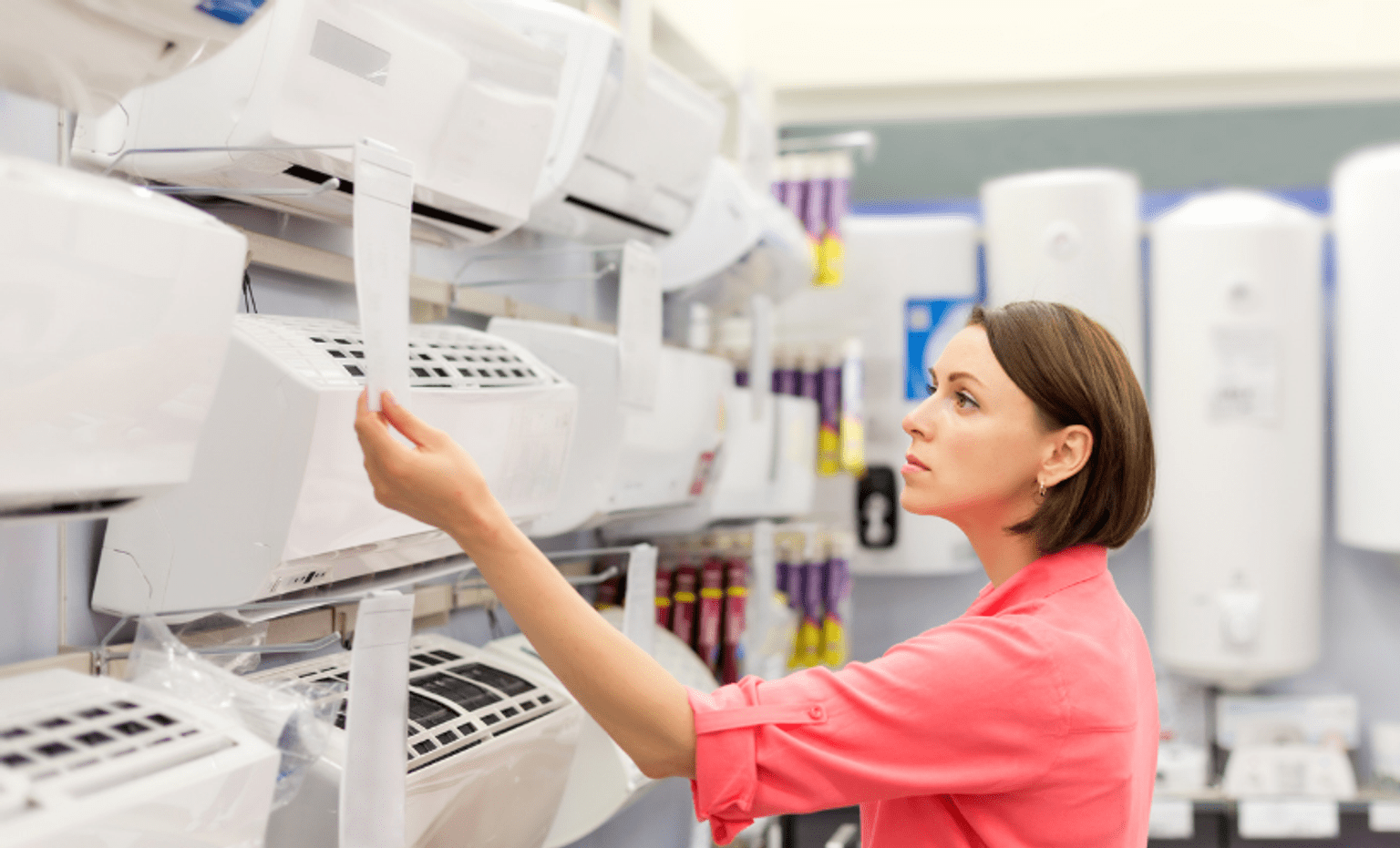 Woman in the shop looking at air conditioners Woman in the shop looking at air conditioners