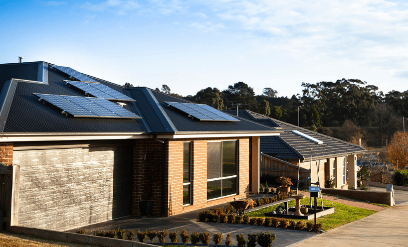 Houses with solar panels installed on roofs. 